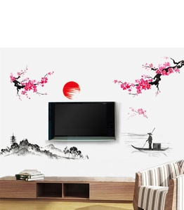 Détail de l'autocollant mural soleil rouge et fleurs de prunier sur un mur