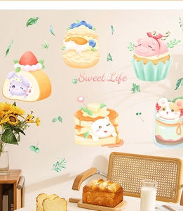 Detail of cute animal dessert wall stickers on a beige wall in a warm kitchen setting