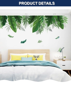Detail of tropical green leaf wall stickers applied as a modern bedroom headboard decor