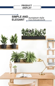 Detail of three tiered wooden wall shelves with artificial green plants in black pots