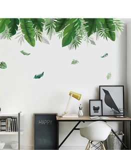 Detail showing tropical green palm leaves wall stickers in a modern home office setting