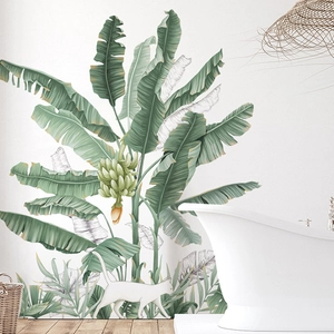 Tropical banana leaf wall decal with a white cat silhouette in a modern bathroom