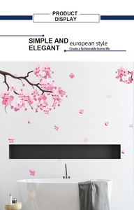 Detail of pink cherry blossom wall stickers paired with a black minimalist wall-mounted rack