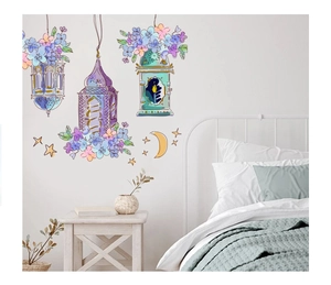Detail of cartoon castle lanterns and blue floral wall stickers in a minimalist bedroom