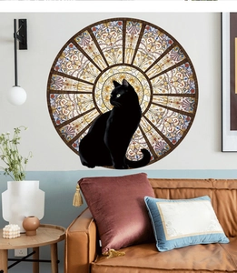 Black cat wall decal with floral glass pattern shown above a brown leather sofa