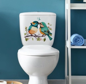 Detail of colorful kingfishers on branch wall decal applied to a white toilet tank