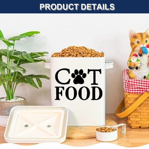 Detail view of white metal cat food storage bin with lid and scoop on a wooden table