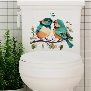 Adhesive bird on floral branch decal for toilet tank with blue hearts decor