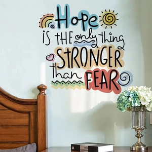 Detail of inspirational quote wall decal with rainbow and sun on mint green wall