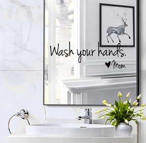 Close-up of 'Wash your hands. Mom' waterproof mirror sticker in a bathroom setting