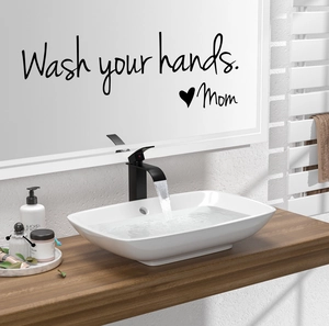Detail of Wash your hands Mom vinyl wall decal applied to a modern bathroom mirror