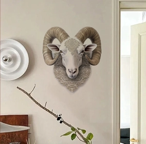 Detailed relief carving on the forehead of a vintage-style decorative ram head sculpture