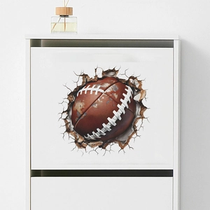 3D wall sticker featuring an American football breaking through a white wall for bedroom decor