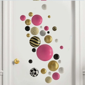Detail showing 3D colorful sphere wall stickers with gold, black, and pink geometric patterns