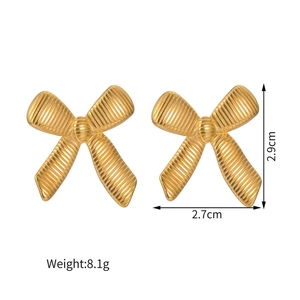 Detailed view of gold bow earrings showing 2.9cm by 2.7cm dimensions and textured finish
