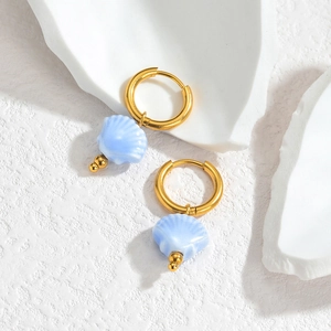 Detail of 18K gold stainless steel hoop earrings with light blue shell pendants