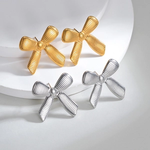 Minimalist bow knot stud earrings in gold and silver finish with textured metal design