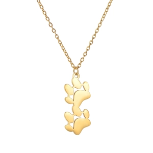 Macro view of gold stainless steel necklace featuring a dual pet paw print pendant design