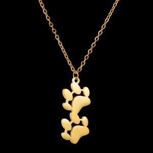 Detailed close-up of golden titanium steel necklace with two vertical animal paw pendants