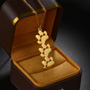 Artistic gold cat paw pendant necklace with organic spheres in a luxury velvet gift box