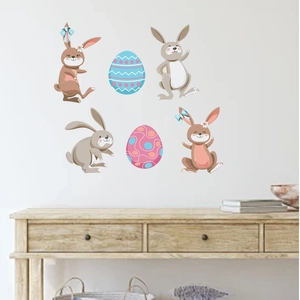 Detail view of Easter bunny wall stickers on a clean wall above a wooden table