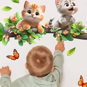 Toddler pointing at cute cartoon cats on flowery branch wall stickers in a cozy room