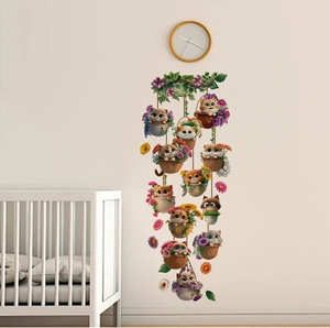 Vertical wall decal showing cute cartoon kittens in floral hanging baskets in a nursery