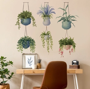 Detailed view of hand-painted floral wall stickers above a desk in a cozy home office setup