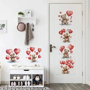 Detail of teddy bear wall stickers with red heart balloons on home door and wall