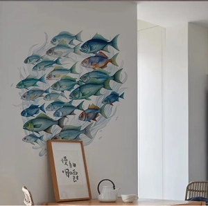 Detail of colorful swimming fish wall decals applied on a white wall in a modern dining room