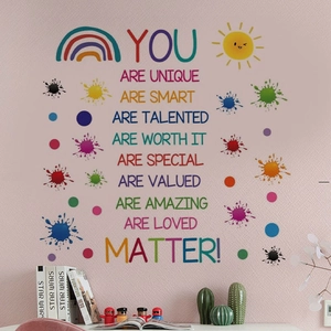 Close-up of colorful rainbow paint splash wall decal with motivational English phrases