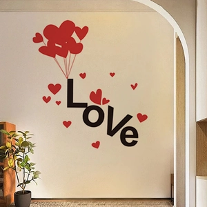 Detail of LOVE wall sticker with red heart balloons on a white living room wall