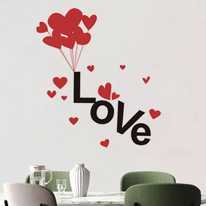 Detailed view of creative wall sticker featuring red heart balloons and black Love letters