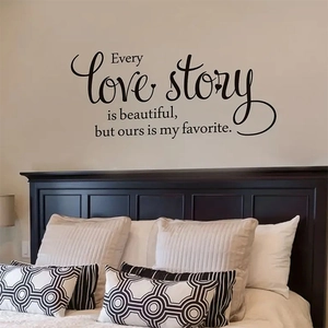 "Every love story is beautiful" black wall sticker above a bed in a modern bedroom