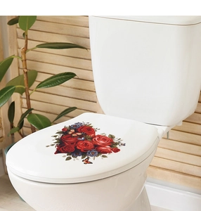 Detail of red roses and butterfly decals applied to a white bathroom toilet lid