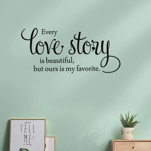Close-up of Love Story wall decal with artistic calligraphy on a mint green wall
