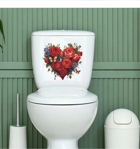 Close-up of heart-shaped red rose toilet stickers with butterflies on a water tank