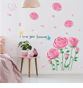 Detail of pink rose wall stickers with 'I love you forever' text in a cozy bedroom