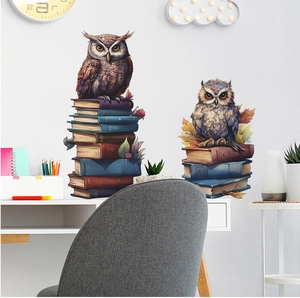 Detail of owl and books wall stickers applied to a white study room wall above a desk