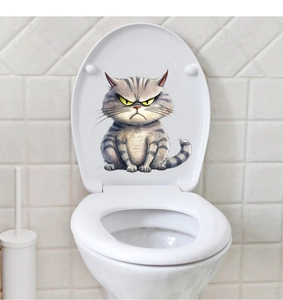 Detail of creative removable wall sticker with a funny angry cat on a white toilet lid