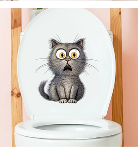 Funny scared grey cartoon cat decal applied on a white toilet lid for bathroom decor