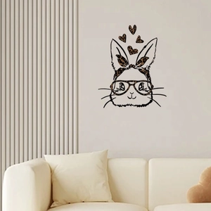 Detail of minimalist wall sticker featuring a rabbit with leopard print bow and heart