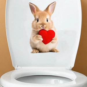 Close-up of a 3D rabbit sticker with a red heart on a white toilet lid for bathroom decor