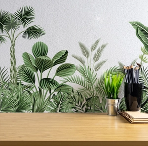 Detail of tropical palm leaves wall stickers in a cozy home office setting with desk decor