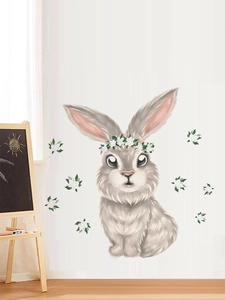 Detail of cute Easter bunny wall sticker with a flower wreath on a white wall