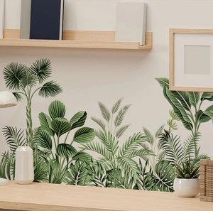 Detail of tropical palm and monstera leaf wall stickers in a modern living room