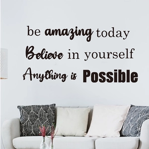 Detail of 'be amazing today' motivational wall stickers above a sofa in a living room