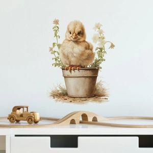 Detail of a cute chick in a flowerpot wall sticker on a white bedroom wall
