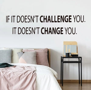 Detail of 'If it doesn't challenge you' wall sticker in black bold vinyl text