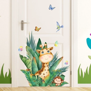 Detail of watercolor giraffe and monkey wall stickers on a white wooden door